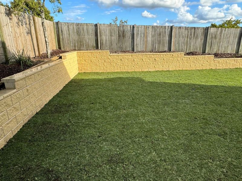 Block retaining wall with fresh turf installation Brisbane