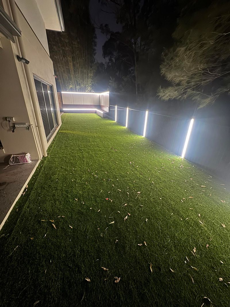 Night landscape lighting on synthetic turf backyard Brisbane