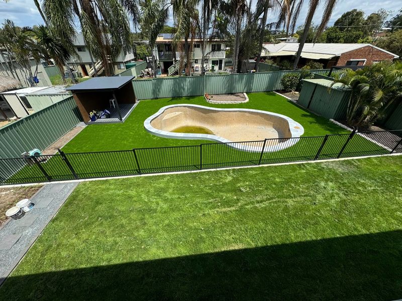 Aerial view of pool area with synthetic turf and fencing Brisbane